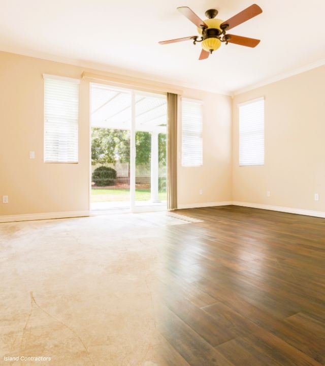 Empty room with worn mixed flooring, before