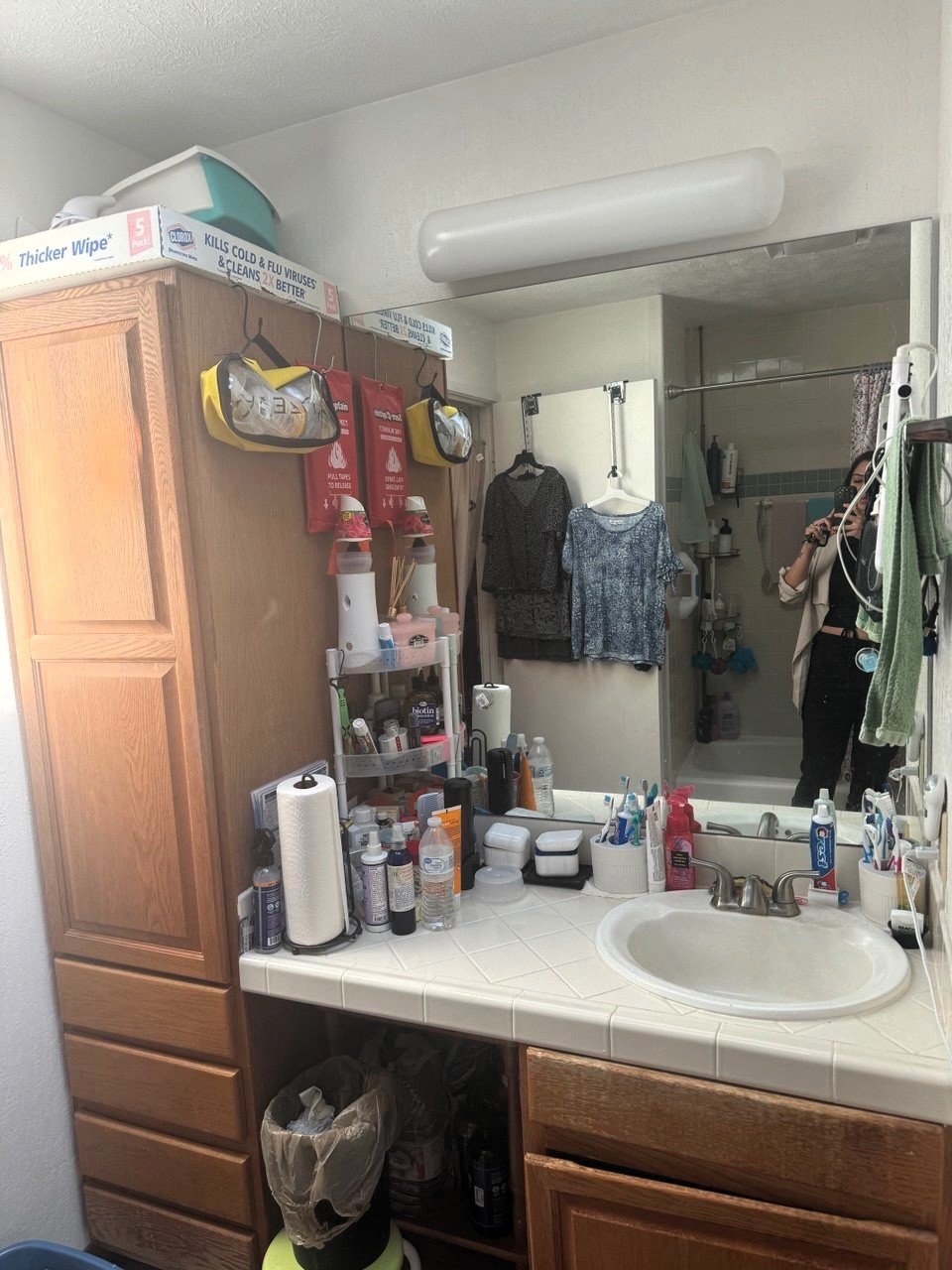 Cluttered dated oak vanity with tile counter, before