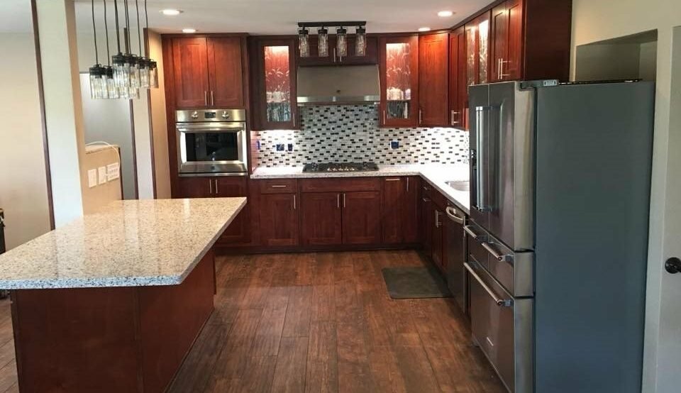 Finished cherry-cabinet kitchen with granite island, after